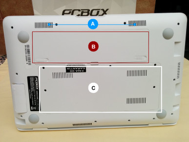 PCBOX Kant: A) Parlantes estéreo frontales. B) batería de 3300 mA. C) Compartimiento de acceso al disco rígido y memoria RAM.